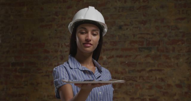 Female Architect Holding Tablet Against Brick Wall - Download Free Stock Images Pikwizard.com