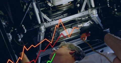 Mechanic inspecting vehicle undercarriage with diagnostic probe and neon data overlay