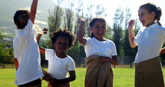 Kids Enjoying Fun Sack Race at Outdoor Sports Event - Download Free Stock Images Pikwizard.com