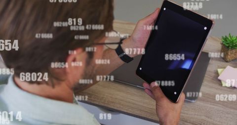 Man Analyzing Dynamic Data on Tablet Screen