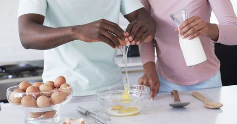 Couple Cooking Breakfast in Kitchen, Preparing Eggs and Milk - Download Free Stock Images Pikwizard.com