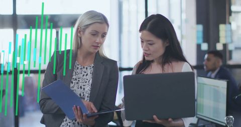 Diverse Business Proffessionals Analyzing Financial Data in Modern Office