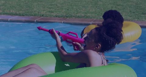 Woman Playfully Shooting Water Gun While Relaxing in Pool