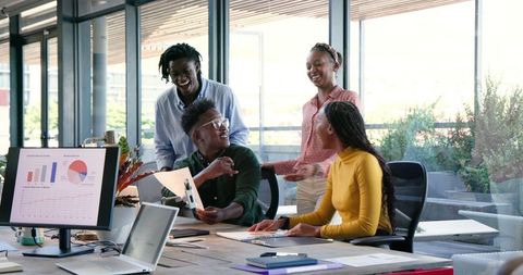 Team Collaborating Over Data in Modern Office Setting