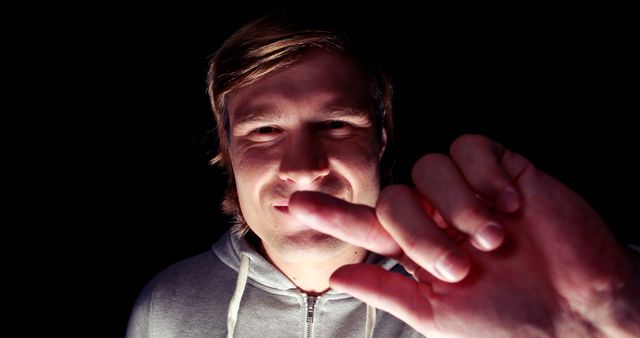 Man Pointing Toward Camera in Low Light - Download Free Stock Images Pikwizard.com