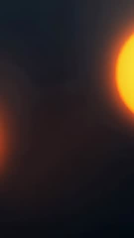 Vertical amber bokeh video featuring glowing right orange light with warm halo and soft blur