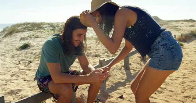 Couple Enjoying Leisure Time at Sandy Beach on a Sunny Day - Download Free Stock Images Pikwizard.com