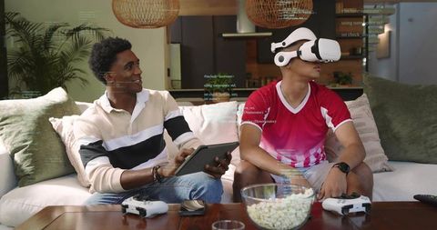 Friends playing vr and tablet multiplayer on couch, enjoying casual gaming night