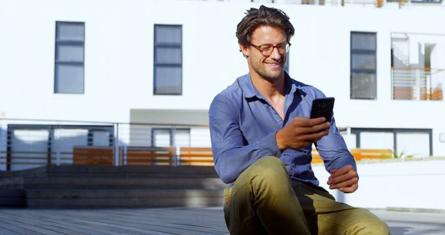 Smiling Man Texting On Smartphone Outdoors On Sunny Day - Download Free Stock Images Pikwizard.com