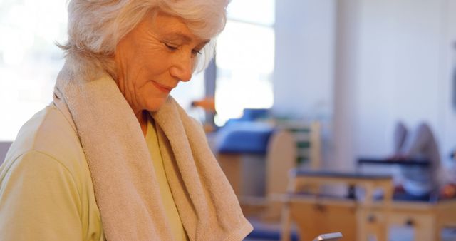 Senior Woman in Fitness Center using Smartphone - Download Free Stock Images Pikwizard.com