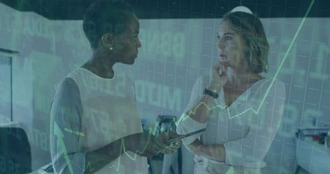 Businesswomen Analyzing Digital Financial Charts