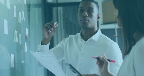 Colleagues Collaborating on Graphs Discuss Data Analysis