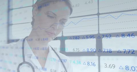Female Doctor Studying Clinical Data on Transparent Glass Display with Stethoscope