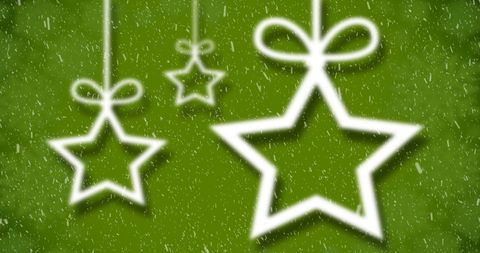 Hanging star christmas ornaments with snow on green background