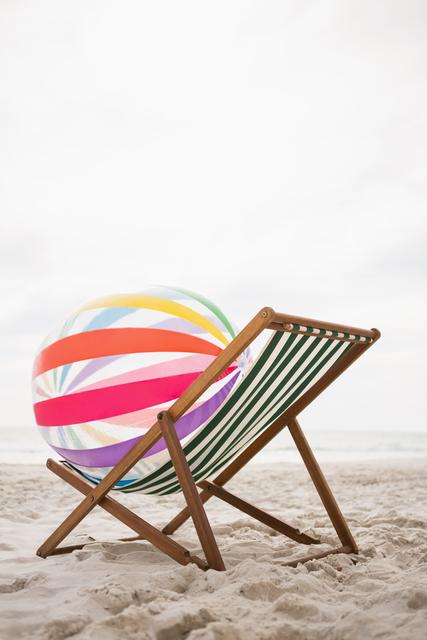 Striped Beach Ball on Empty Chair at Tropical Sand Beach - Download Free Stock Photos Pikwizard.com