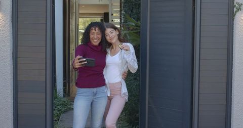 Diverse Female Friends Taking Selfie in Modern Home Entryway