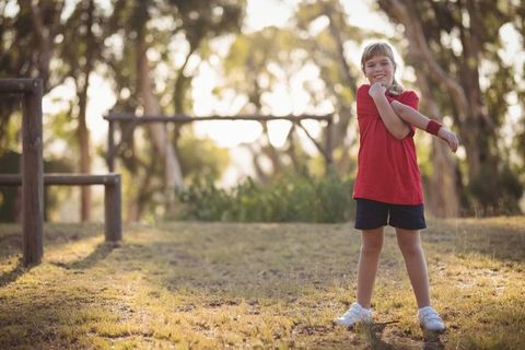 Child Stretching in Park for an Enjoyable Outdoor Activity