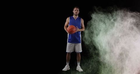 Basketball player with colorful smoke effect captures focused energy