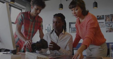 Creative team discussing photography projects in studio environment