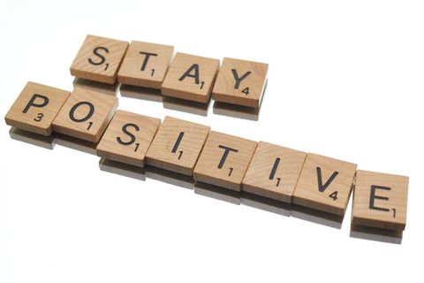 Wooden letter tiles spelling stay positive inspiration message