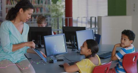 Diverse Classroom Learning with Computers and Teacher Guidance - Download Free Stock Images Pikwizard.com