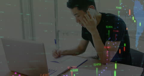 Businessman Analyzing Financial Data While on Phone Call