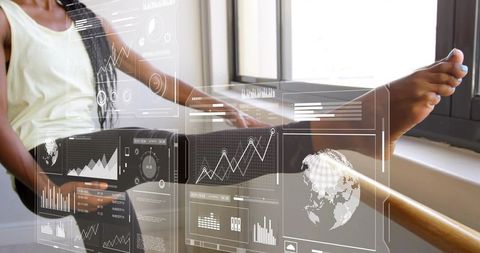 Stretching dancer at barre with digital overlays, global charts and sunlit studio window