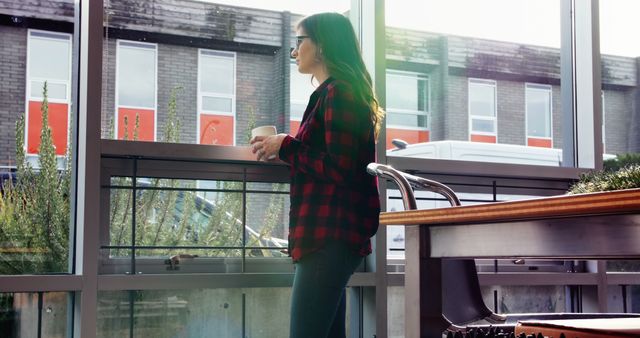 Woman in Red Plaid Shirt Relaxing with Coffee by Large Window - Download Free Stock Images Pikwizard.com