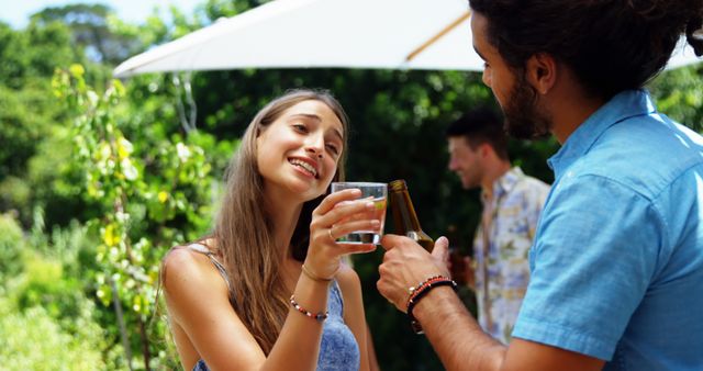 Friends Enjoying Drinks at Outdoor Barbecue Gathering - Download Free Stock Images Pikwizard.com