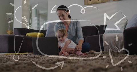 Woman holding baby watching laptop on cozy living room rug with playful doodle overlay