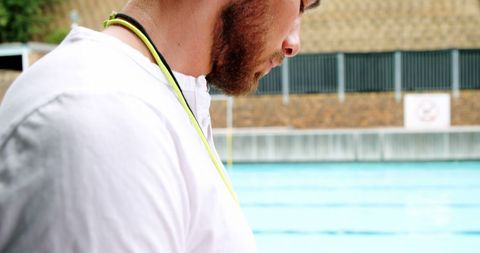 Focused Poolside Trainer Overseeing Swimming Pool Activities - Download Free Stock Images Pikwizard.com