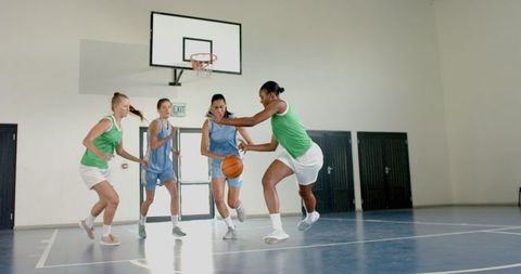 Female Basketball Players Competing in Intense School Gym Match