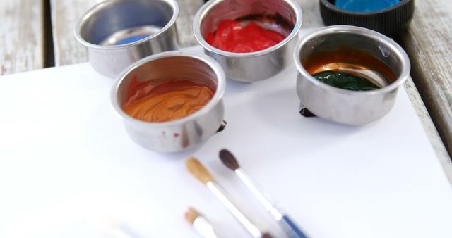 Art Supplies with Paintbrushes and Paint Cups on Blank Canvas - Download Free Stock Images Pikwizard.com