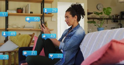 Biracial Woman Engaging with Social Media on Smartphone at Home