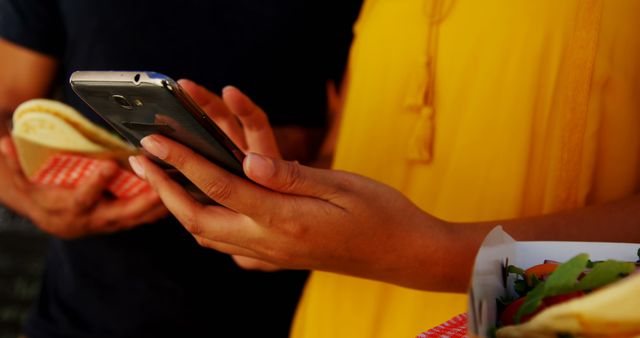 Close-Up of Hands Texting While Holding Tacos in Outdoor Cafe - Download Free Stock Images Pikwizard.com