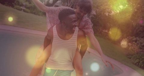 Playful Piggyback Couple by Backyard Pool at Golden Hour with Warm Bokeh Light