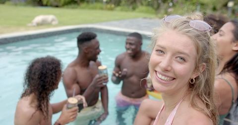 Young Woman Enjoying Pool Party with Friends Relaxing
