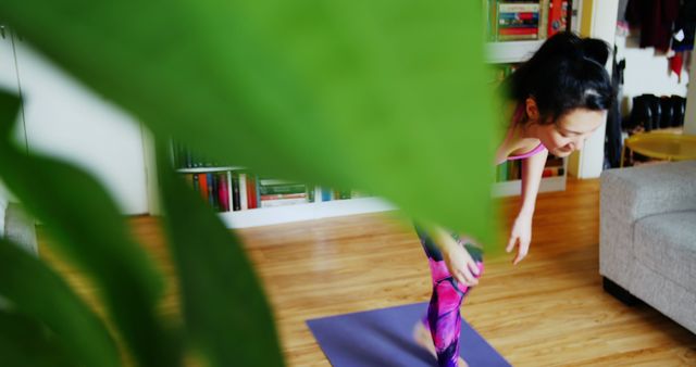 Woman Practicing Yoga at Home Behind Green Plant - Download Free Stock Images Pikwizard.com