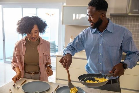 Cheerful Couple Enjoy Cooking Together in Modern Kitchen