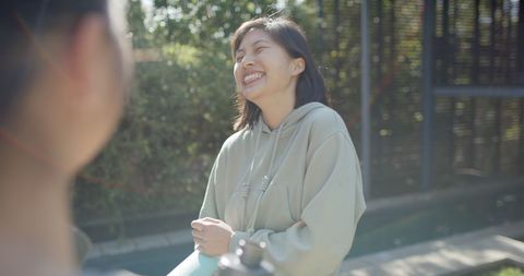 Smiling Friends Outdoors Enjoying Fitness Conversation