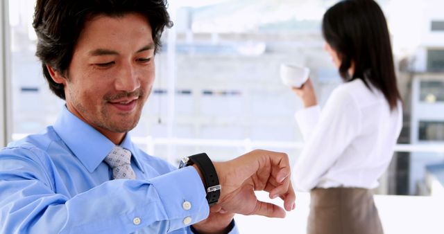 Businessman Checking Time on Smartwatch in Office Meeting - Download Free Stock Images Pikwizard.com