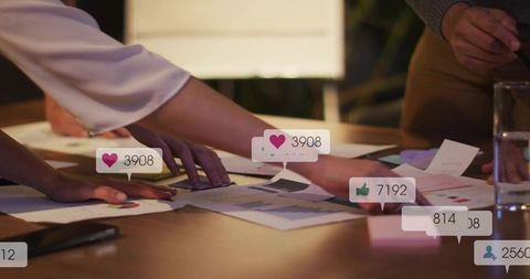 Team Collaborating Over Social Media Metrics and Printed Charts for Data-Driven Planning