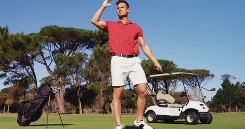 Confident Golfer Celebrating Successful Shot on Lush Green Course