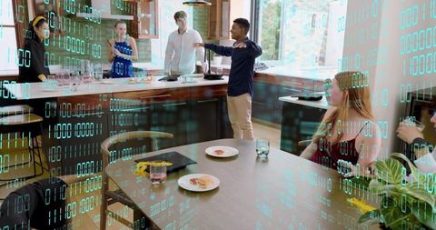Presenting team collaborating around modern kitchen island with digital data overlay