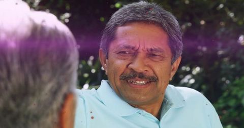 Senior Man Enjoying Outdoor Conversation in Garden Tranquility