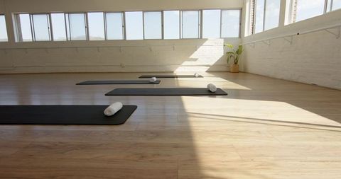Sunlit Yoga Studio with Prepared Mats for Relaxation - Download Free Stock Images Pikwizard.com