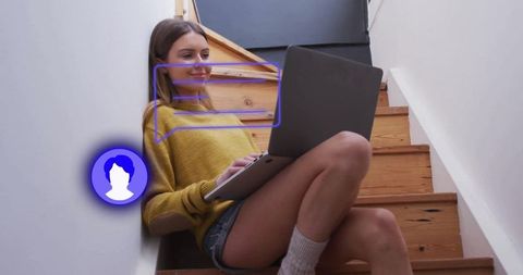 Woman relaxing on stairs with laptop in cozy home environment