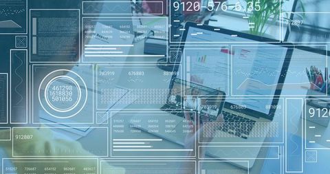 Open laptop displaying HUD dashboards and charts with team collaborating in modern workspace