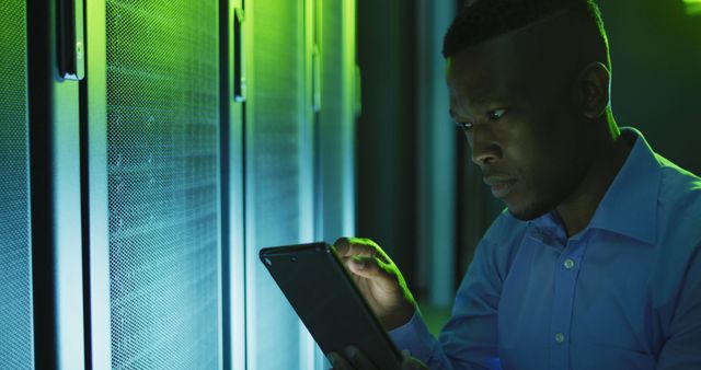 A data center technician is using a tablet to perform maintenance and inspection tasks in a server room. This can be used to illustrate technology, IT infrastructure, server management, or professional support roles.