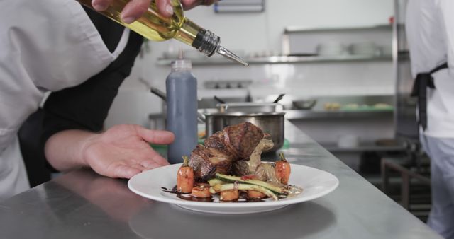 Chef finishing perfect steak plating with olive oil in professional kitchen - Download Free Stock Images Pikwizard.com